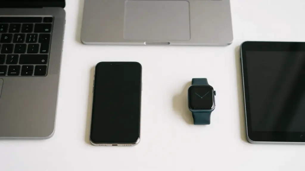 Refurbished smartphones, laptops, tablets, and wearables on a modern desk